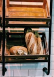 Close-up of artisanal bread and bakery products on wooden shelves
