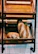 Interior shot of a cozy bakery corner with wooden shelves filled with fresh bread.