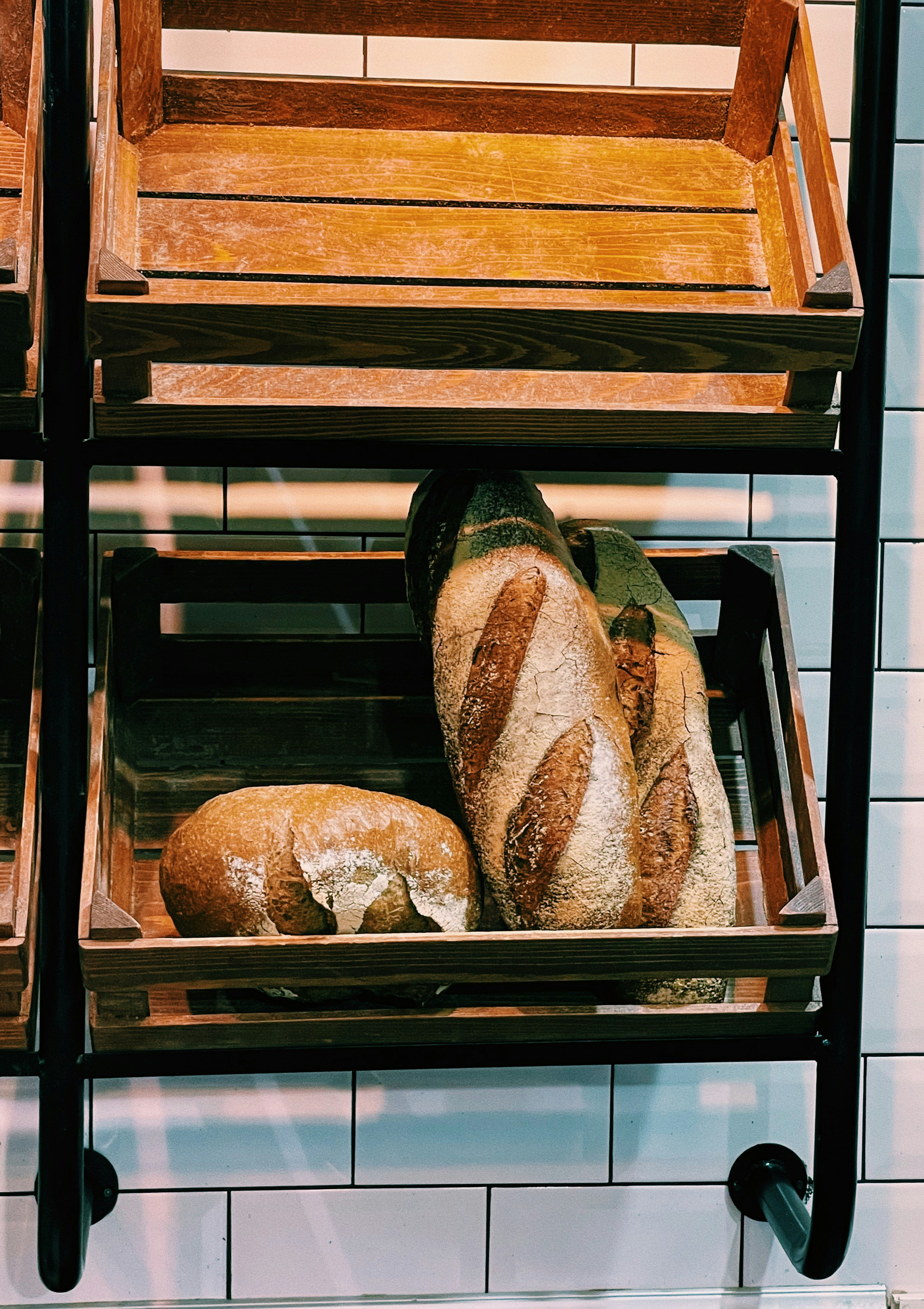 a couple of shelves filled with bread on top of a counter