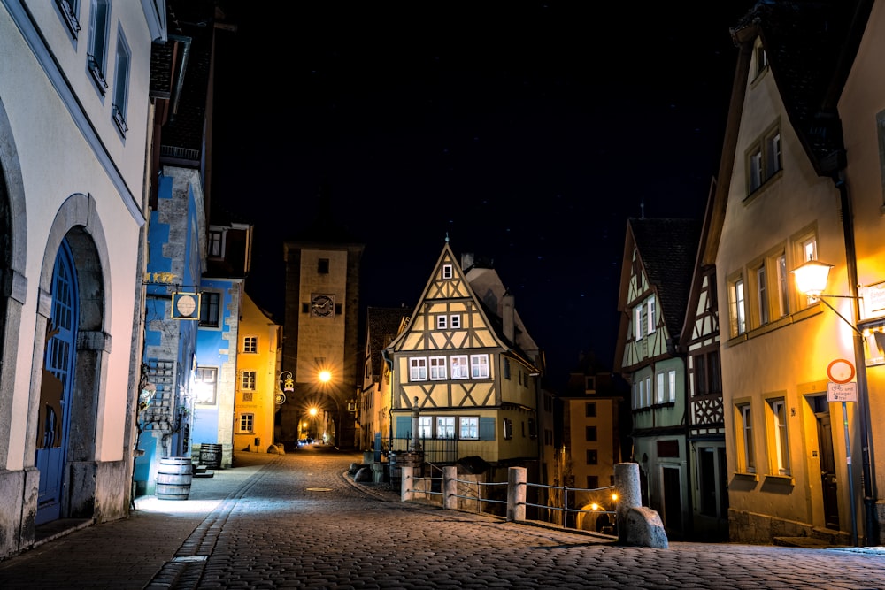a cobblestone street at night in a european city