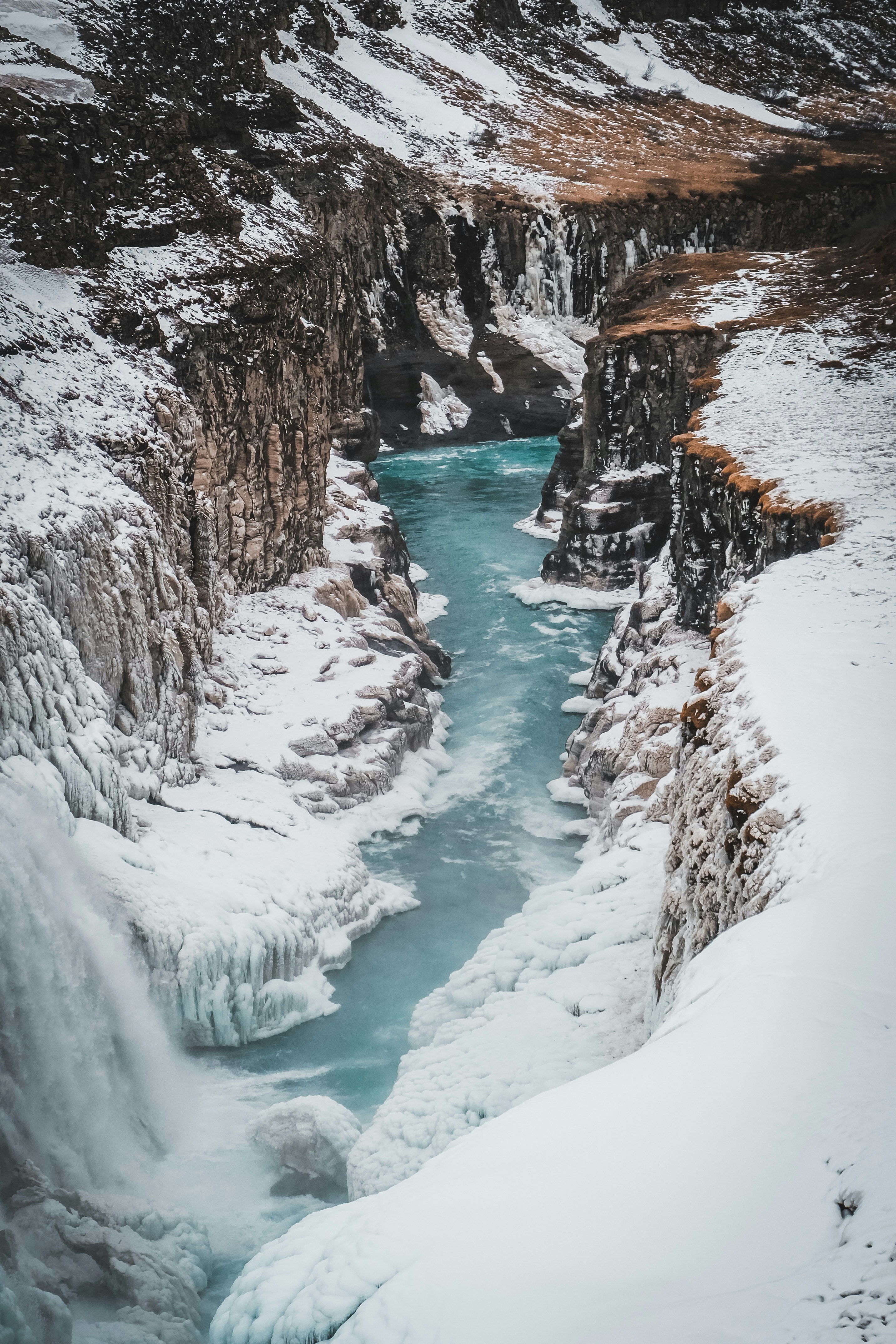 a river running through a snow covered canyon