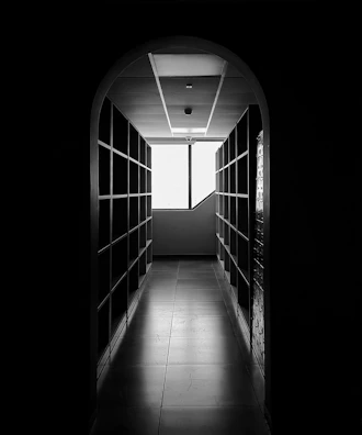 A bright hallway featuring wall-mounted shelves perfectly aligned and secured.