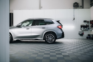 a silver bmw suv parked in a garage