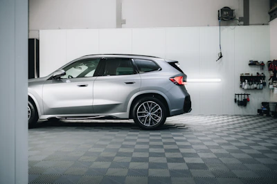 a silver bmw suv parked in a garage