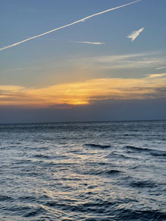 A peaceful ocean view from the spa’s relaxation lounge, bathed in the glow of a golden sunset.