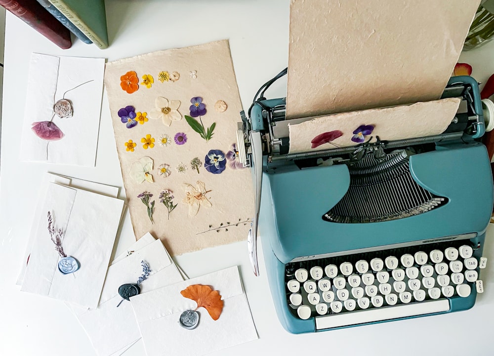 a blue typewriter sitting on top of a white table