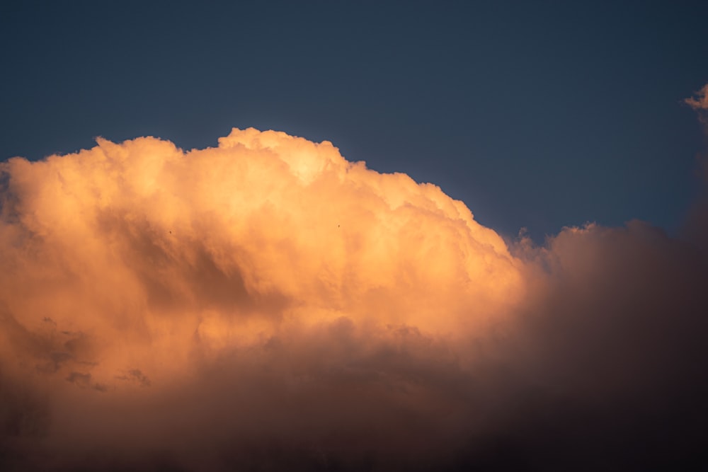 a plane flying in the sky with a lot of clouds