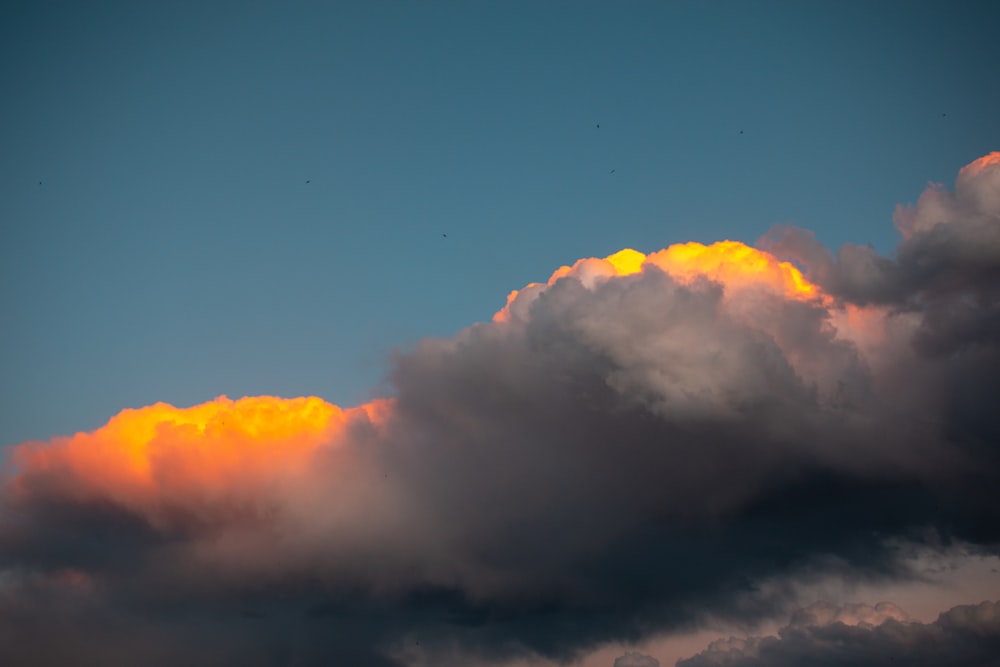 a plane flying in the sky with a lot of clouds