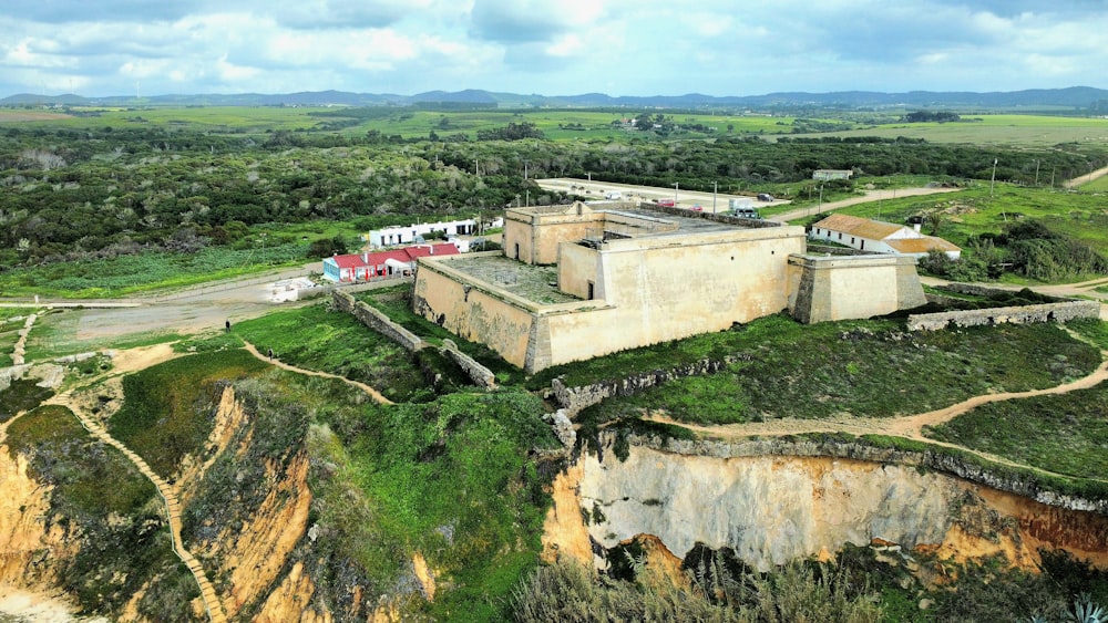 an aerial view of a large building on a cliff