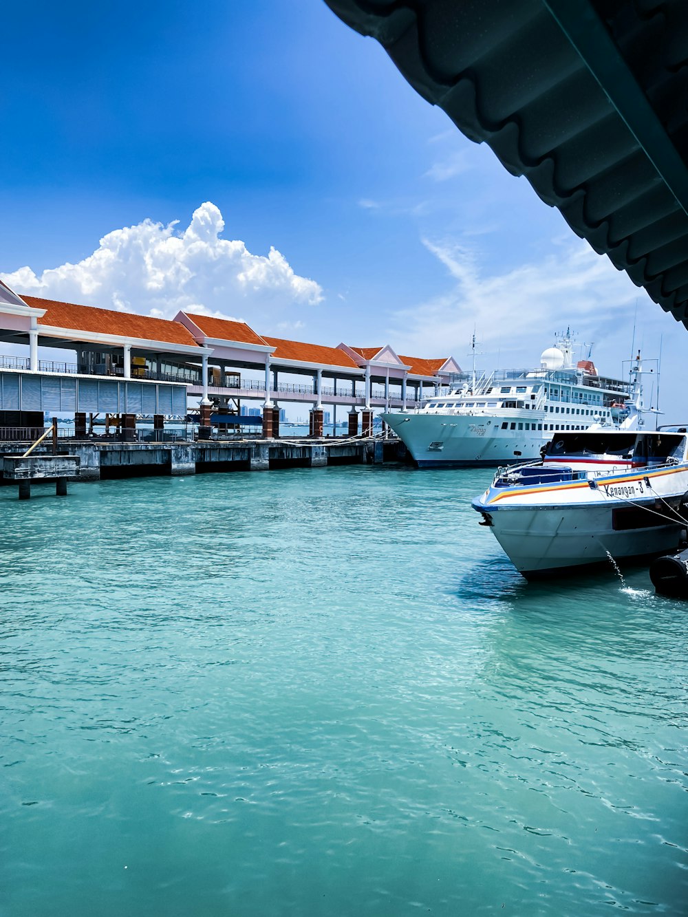 several boats docked at a pier in the water