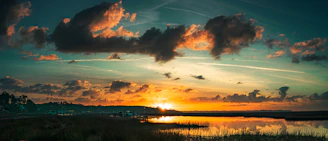 A serene Carolina Low Country marsh at sunset with soft golden light reflecting on the water.