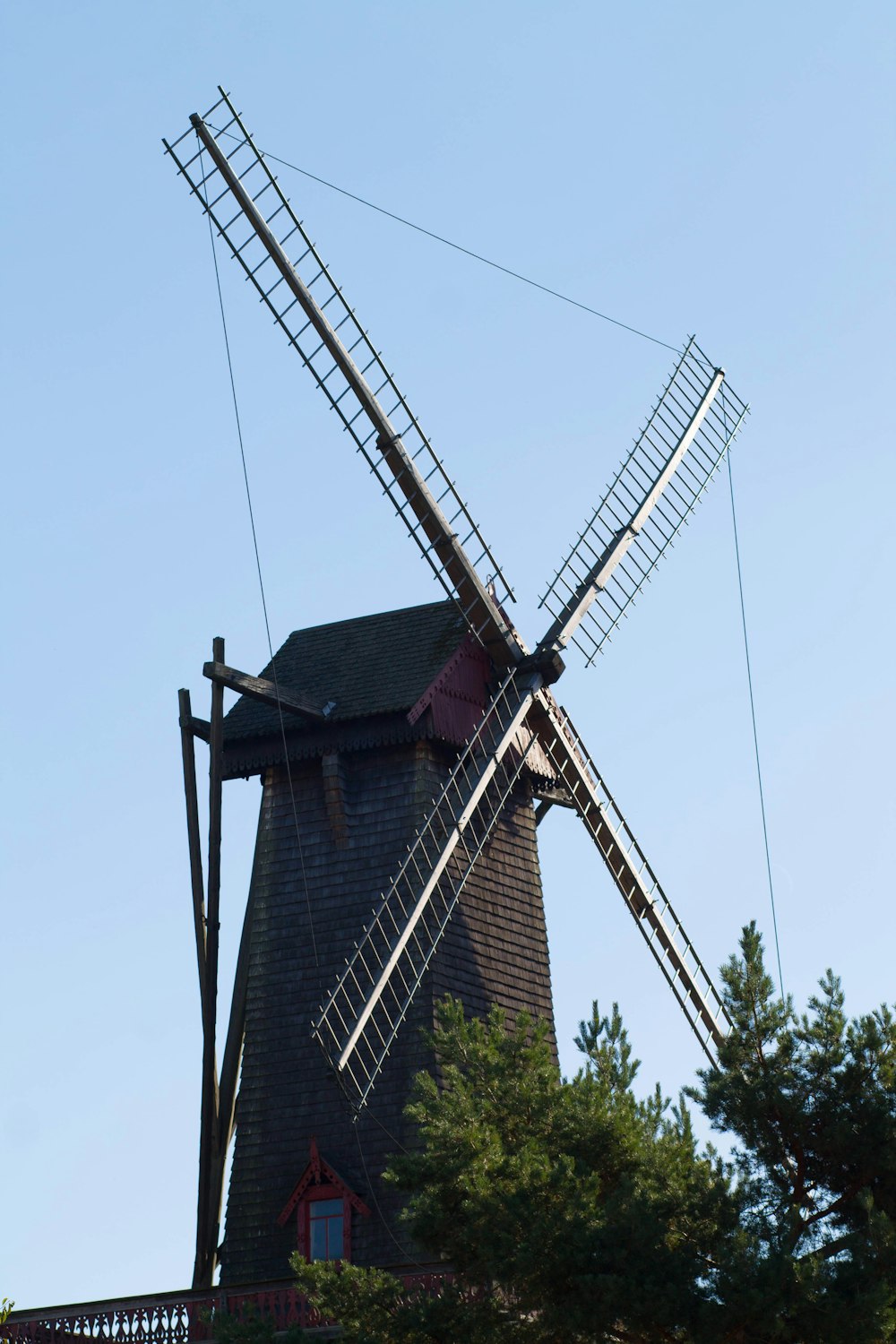 a large windmill with a red door on top of it