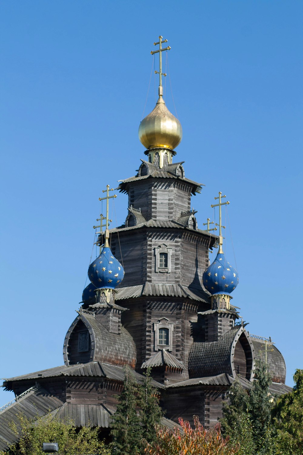 a church with a golden dome and blue domes