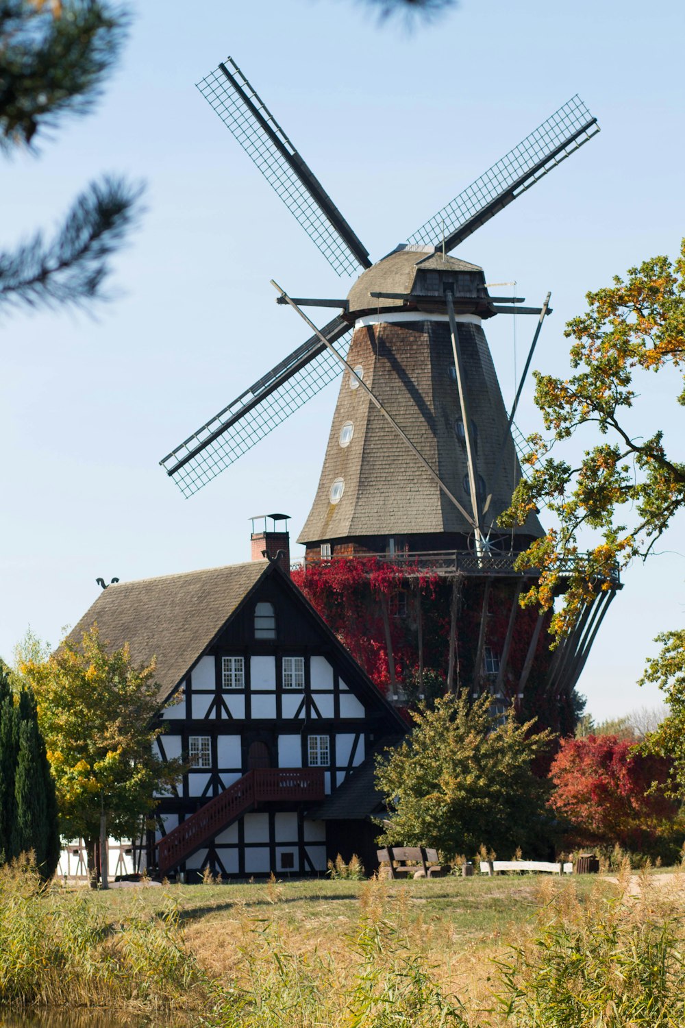 a windmill sitting on top of a lush green field