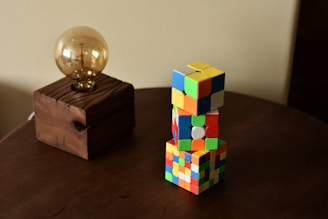 a wooden table topped with a wooden block and a golden ball