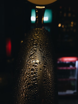Close-up of a chilled Amethyst Beverage bottle with condensation.