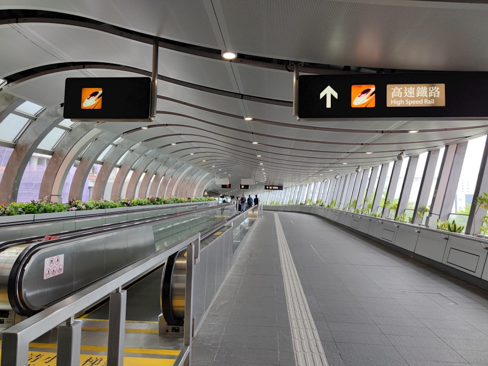 an airport with a long walkway leading to the exit