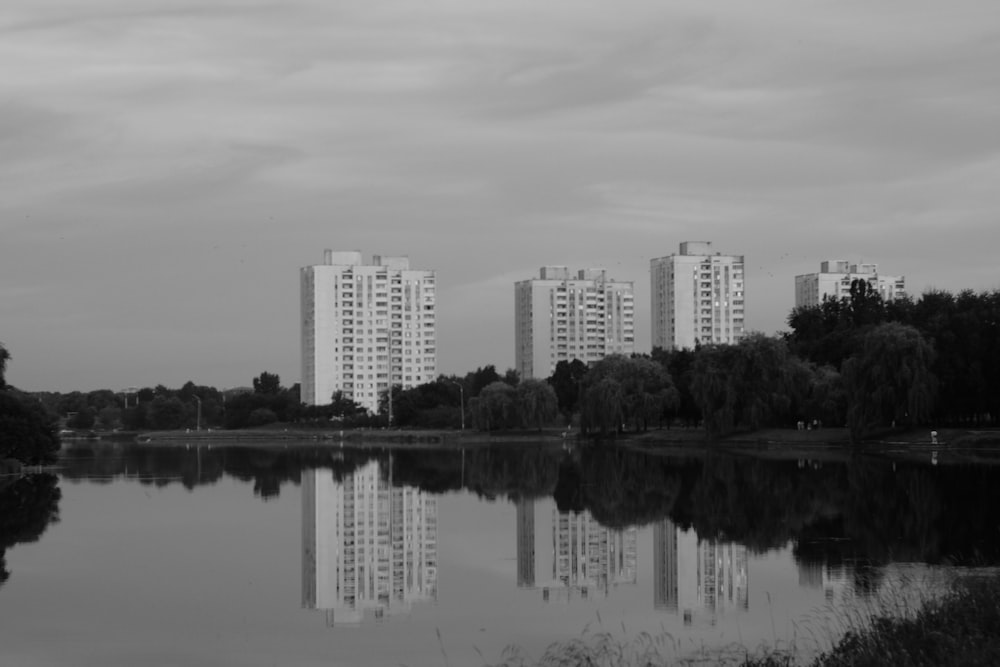 a body of water with tall buildings in the background