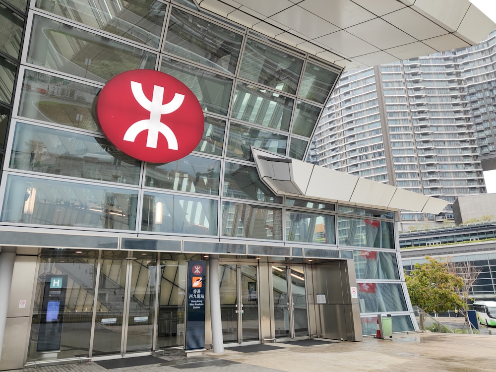 a large building with a red and white sign above it