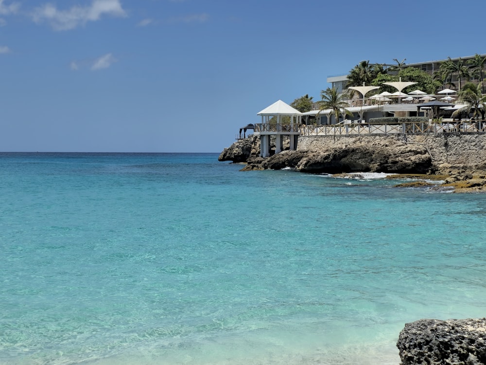 a view of a beach with a restaurant in the background