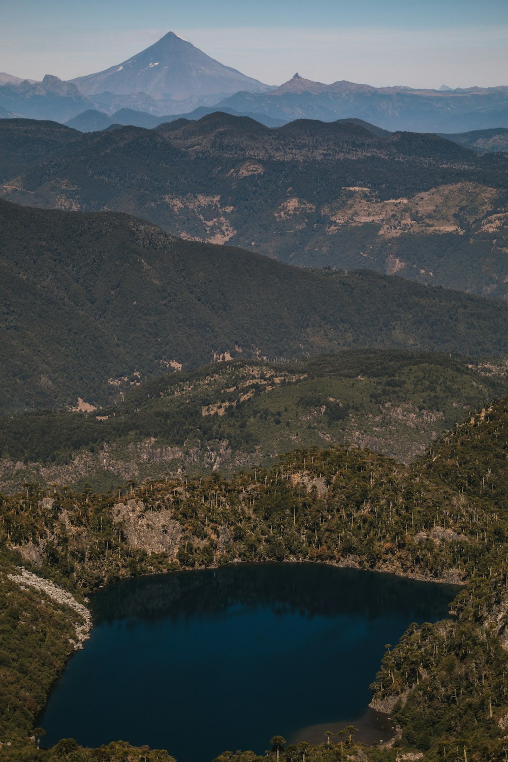 a mountain range with a lake in the foreground