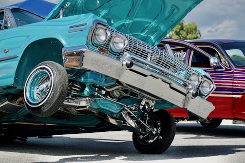 A vibrant lowrider at a car show, surrounded by fans.