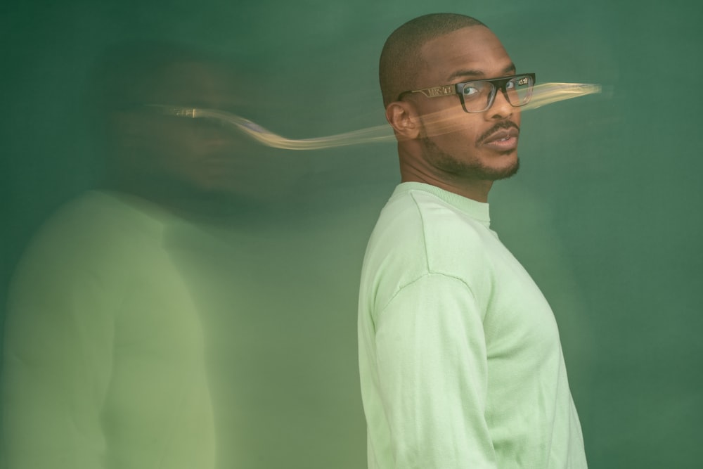 a man wearing glasses and a green shirt