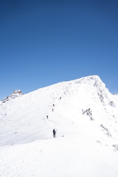 A mountain guide leading a small group along a rocky ridge