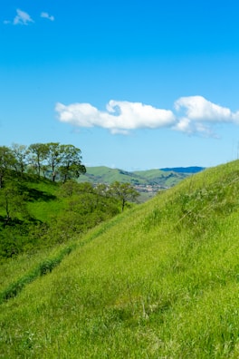 A scenic small town hospital surrounded by rolling hills and open sky