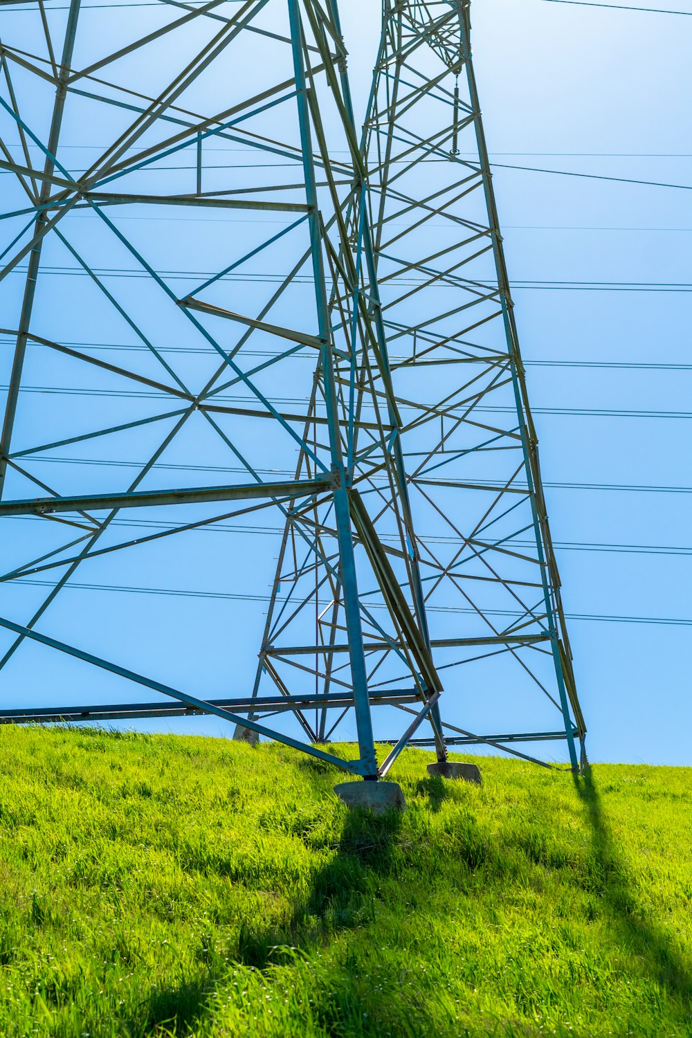 a tall metal tower sitting on top of a lush green field