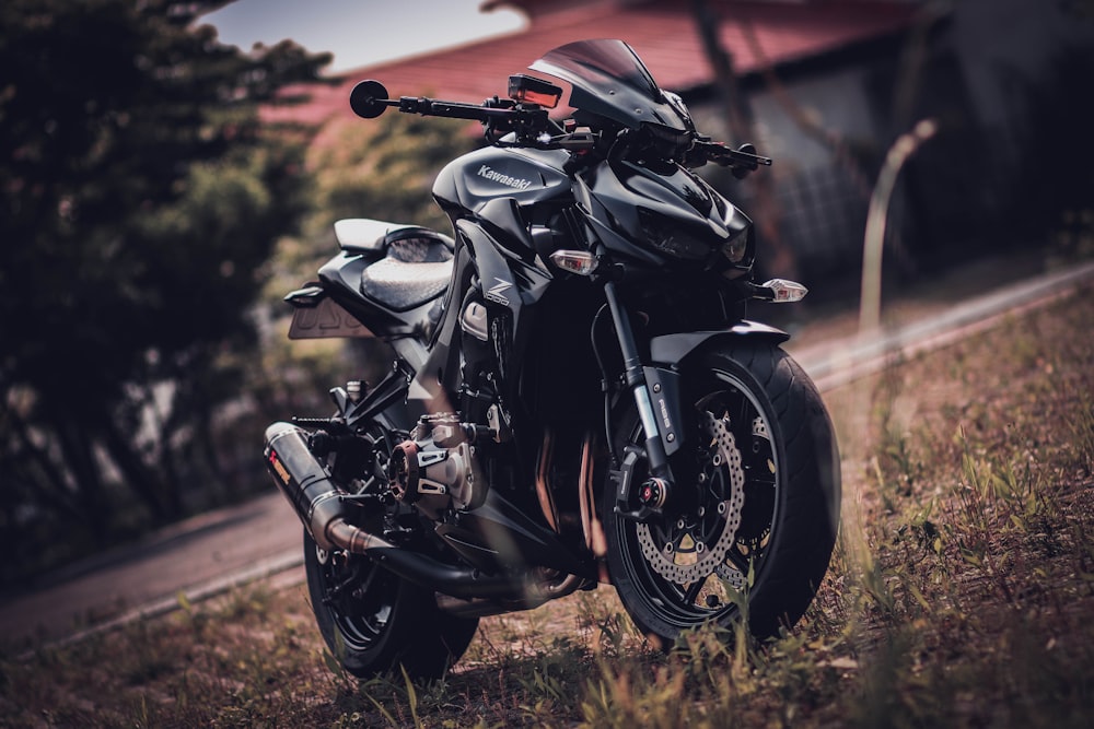 a black motorcycle parked on the side of a road