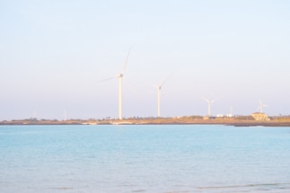 A serene coastal desalination plant at sunrise with calm sea waters.
