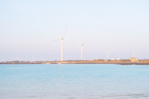 A serene coastal desalination plant at sunrise with calm sea waters.