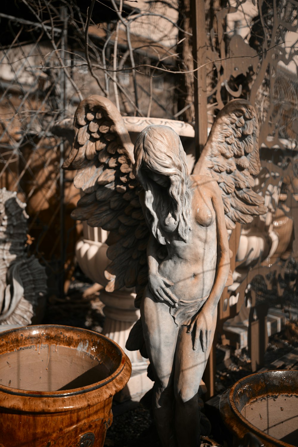 a statue of an angel standing next to a bucket
