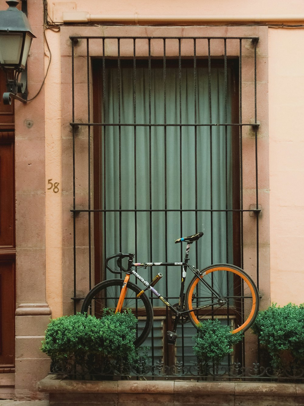a bicycle is parked in front of a window