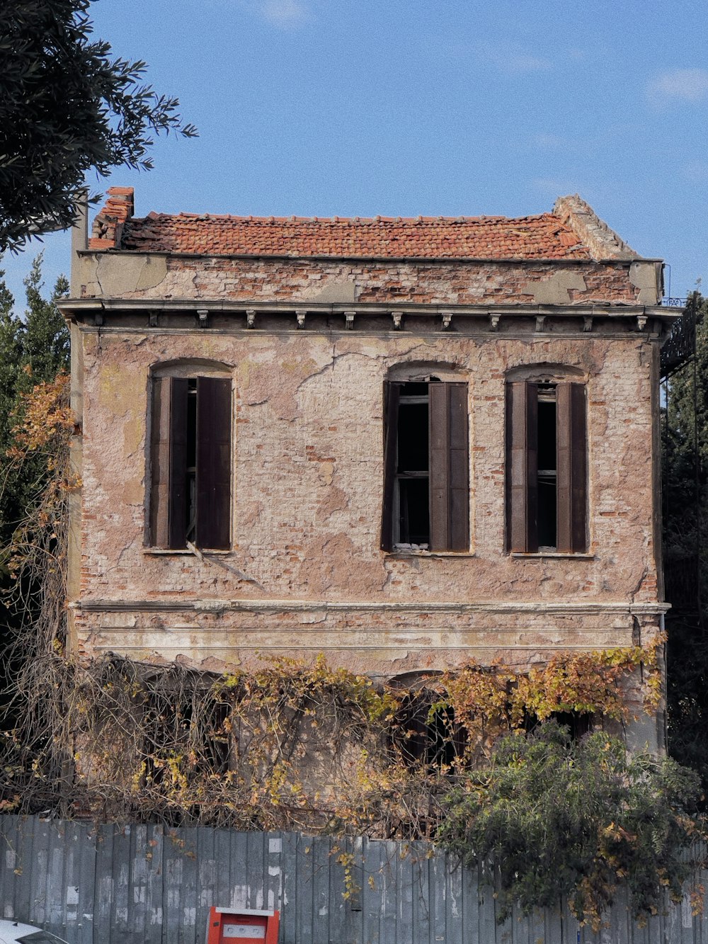 an old building with a red bench in front of it