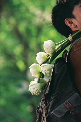 Ta meri bags displayed alongside lotus flowers symbolizing heritage and strength.