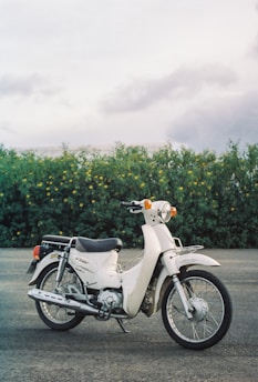 a white motorcycle parked in a parking lot