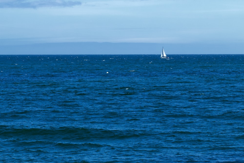 a sailboat in the middle of a large body of water