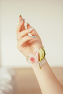 Delicate custom nail art featuring floral designs in pastel tones.