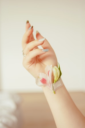 Close-up of delicate floral nail art in soft pastel shades.