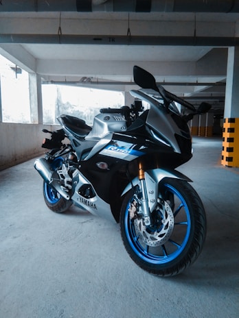 A sleek superbike parked inside the workshop, spotlight highlighting its polished chrome and bold design.
