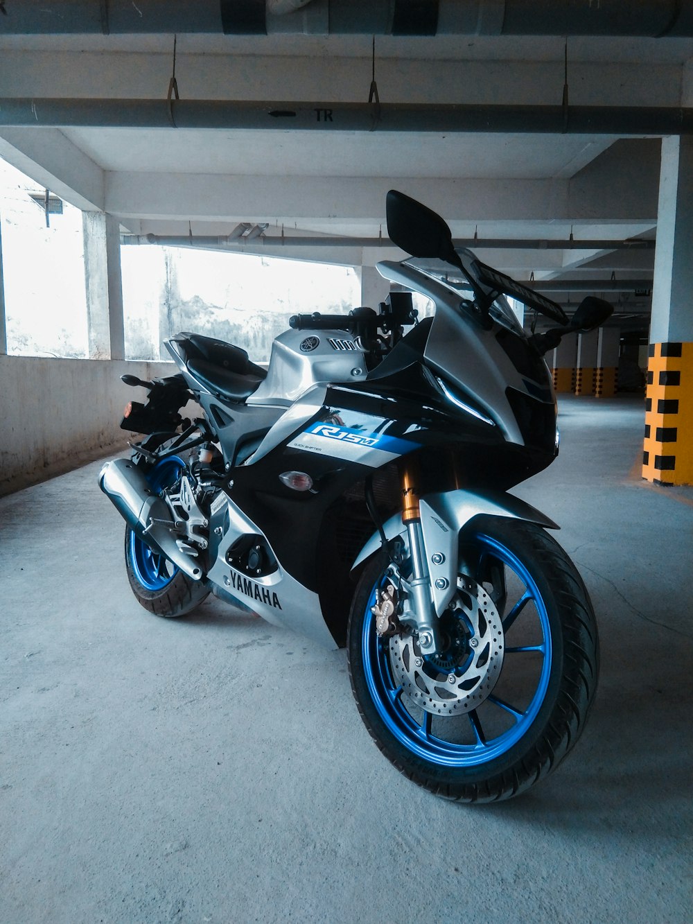 a black and blue motorcycle parked in a garage