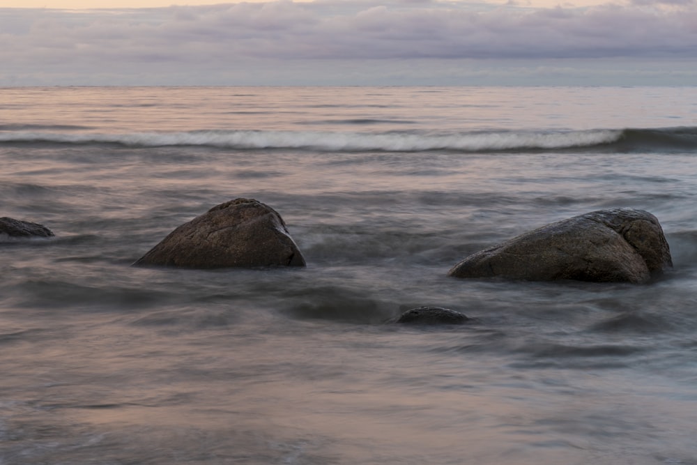 a couple of rocks that are in the water