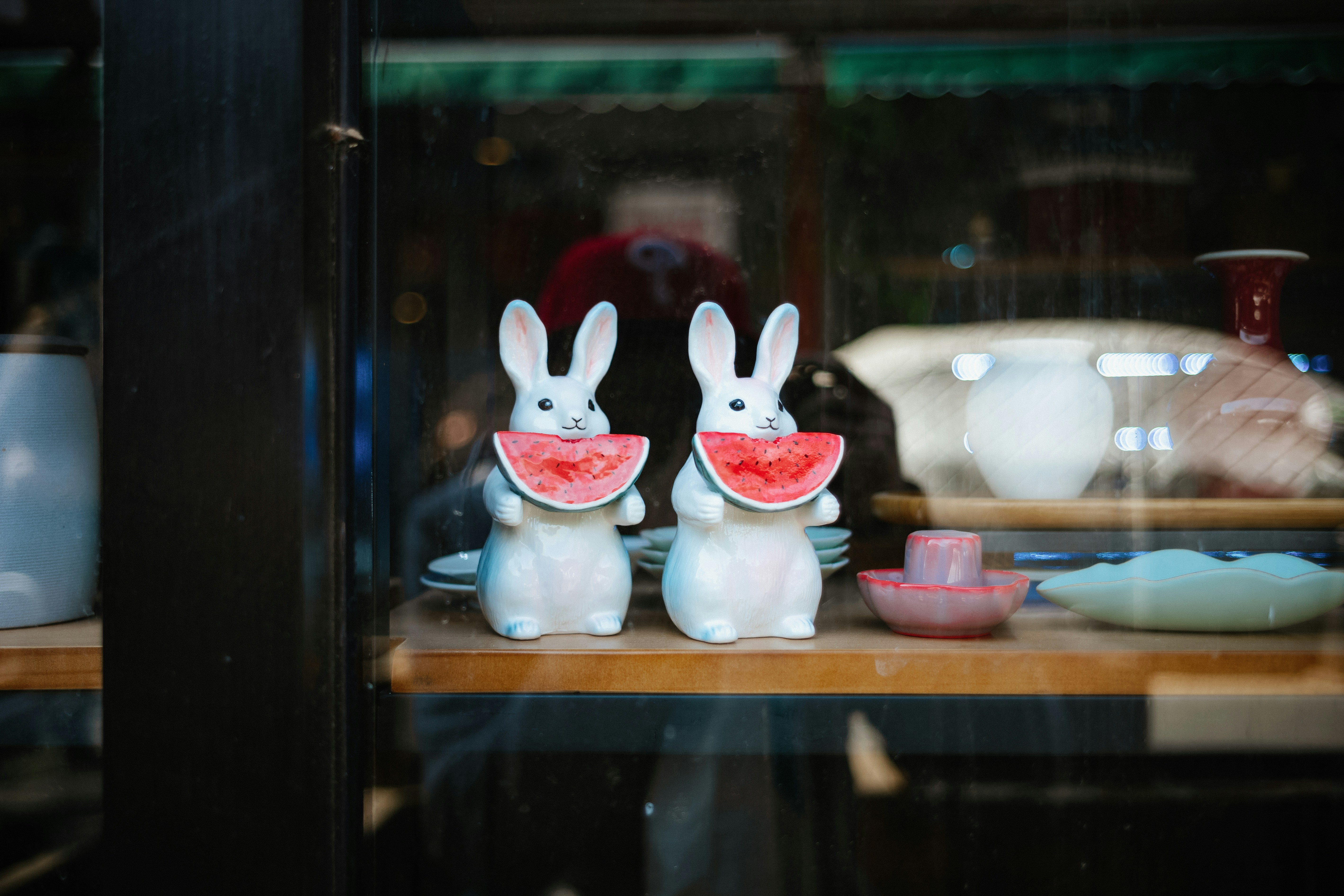a couple of white rabbits sitting on top of a table
