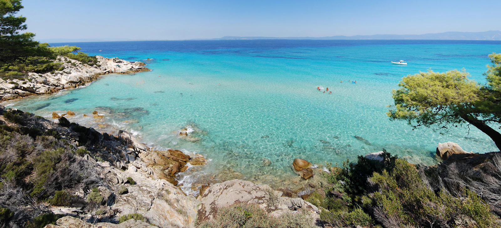 A clear turquoise beach fringed with pines in Halkidiki