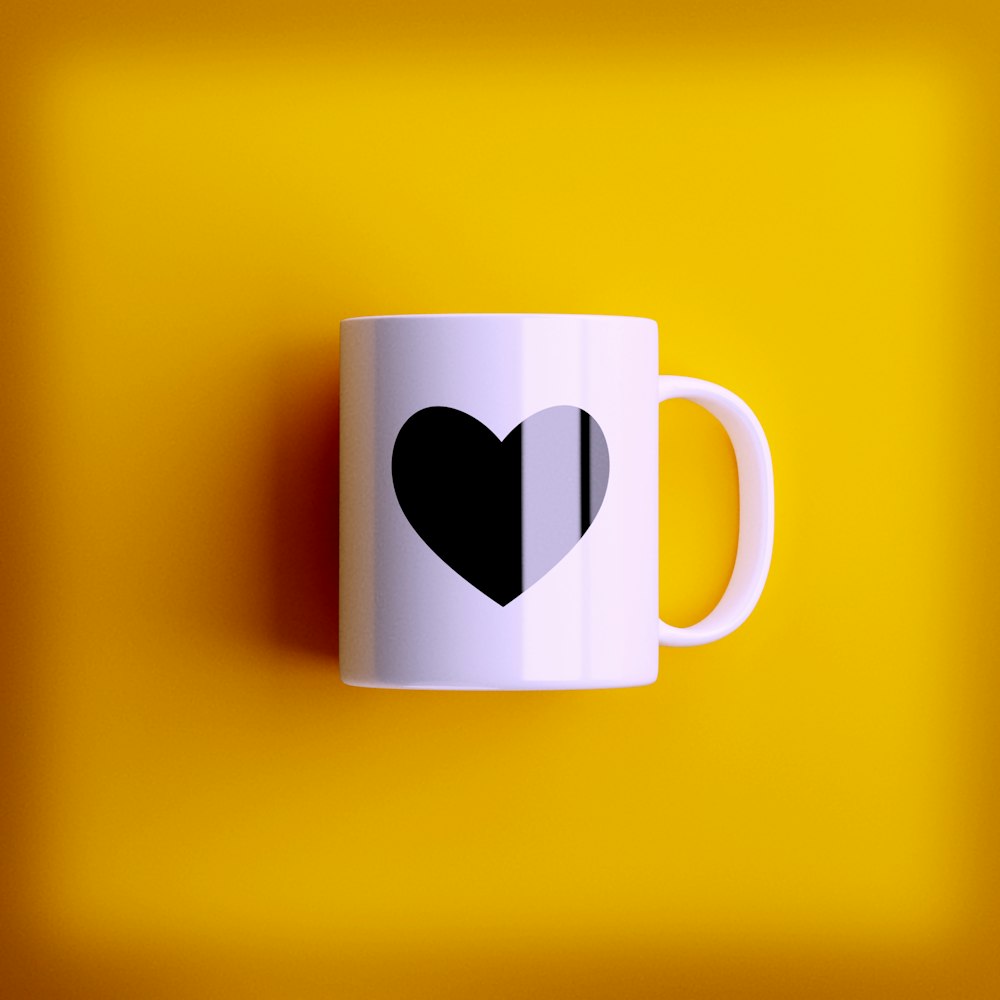 a white coffee mug with a black heart on it