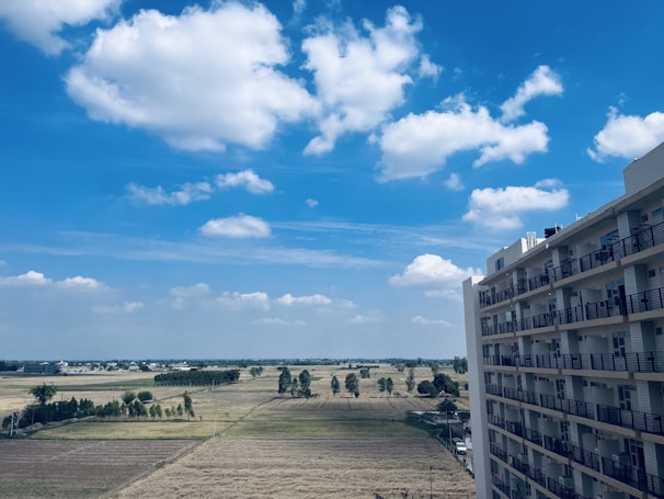 Wide view of the private one-acre retreat surrounded by open fields and blue sky.