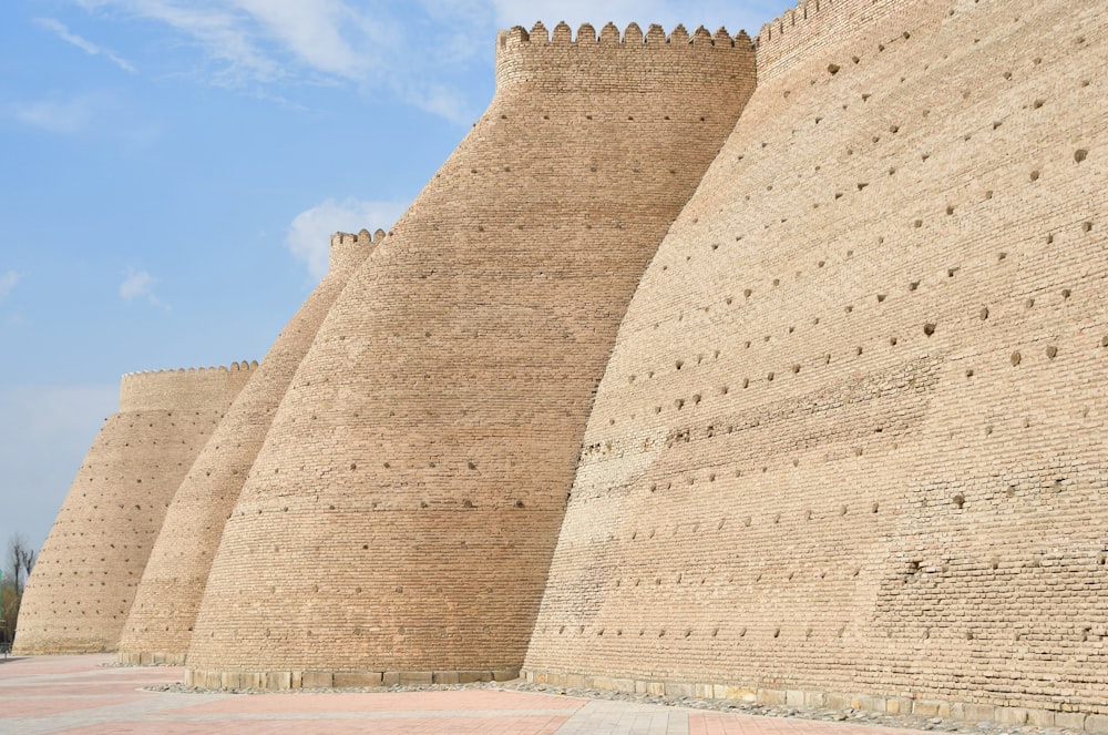 a large brick wall with a clock on it