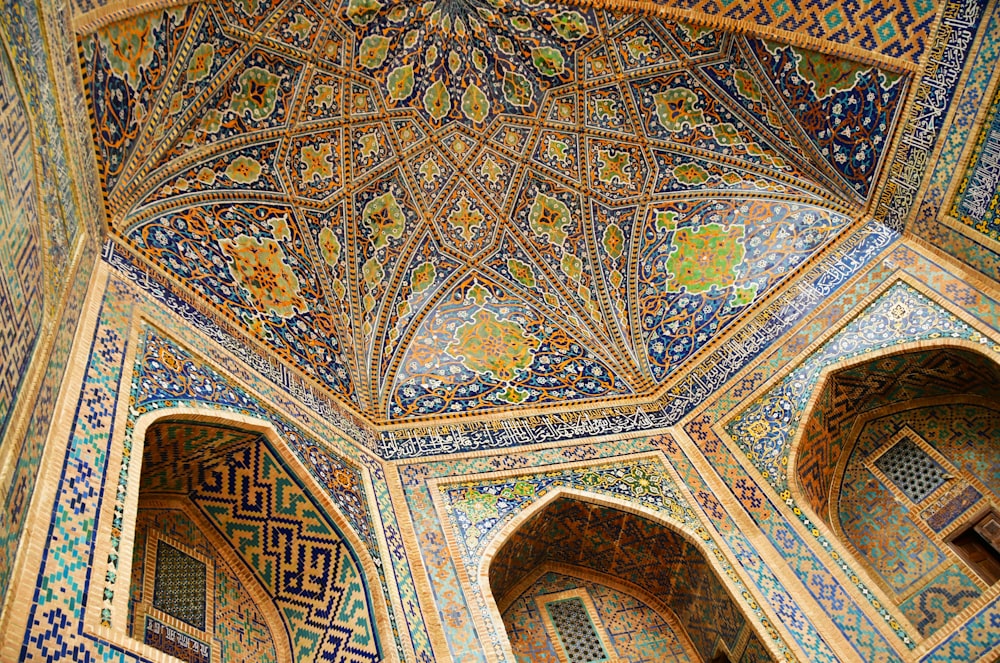 the ceiling of a building with many colorful designs